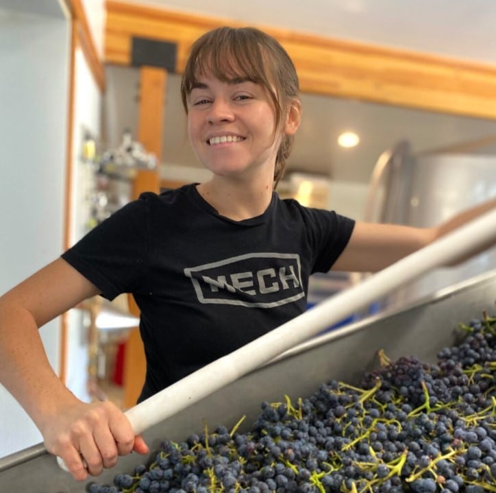 Female Wine Maker Processing Grapes